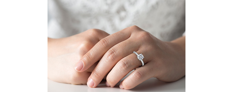 Hand modeling a 1 1/2 carat diamond ring.